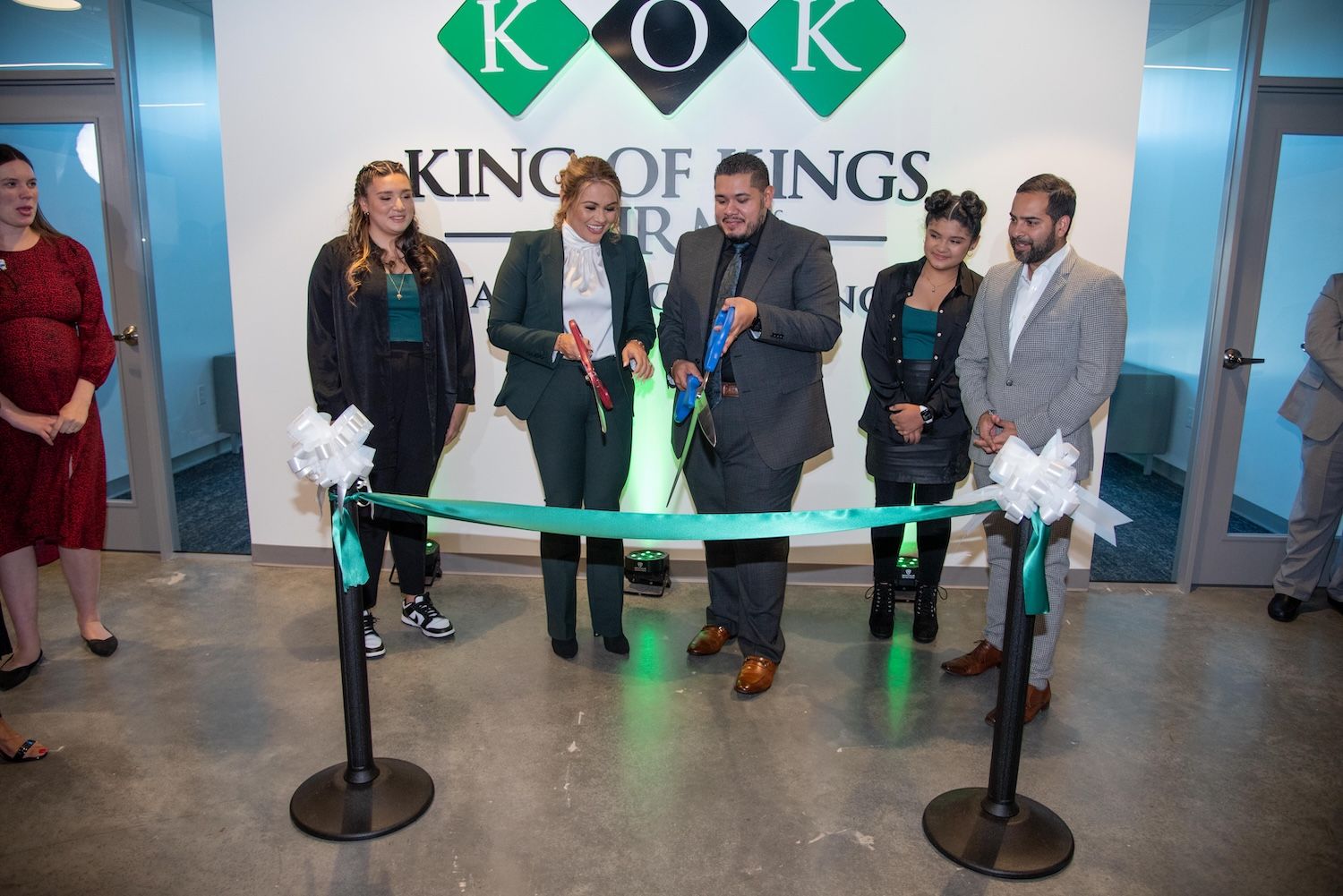People cutting ribbon at King of Kings firm opening ceremony.