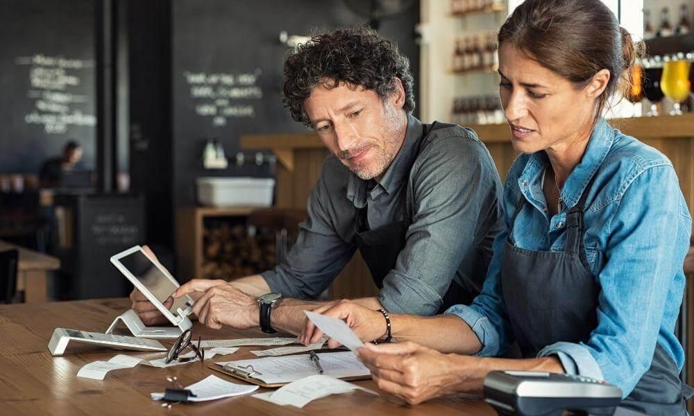 Man and woman reviewing accounting documents