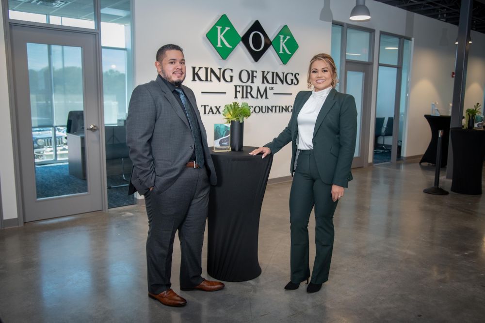 Two professionals at King of Kings Firm office, specializing in tax and accounting services.