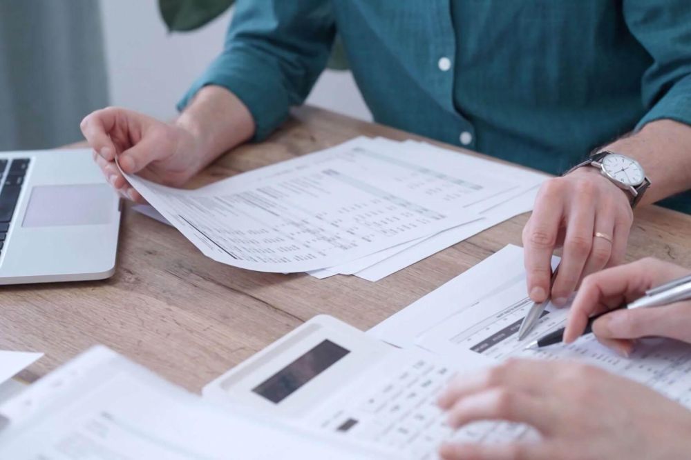 Person reviewing estimated tax documents at a table