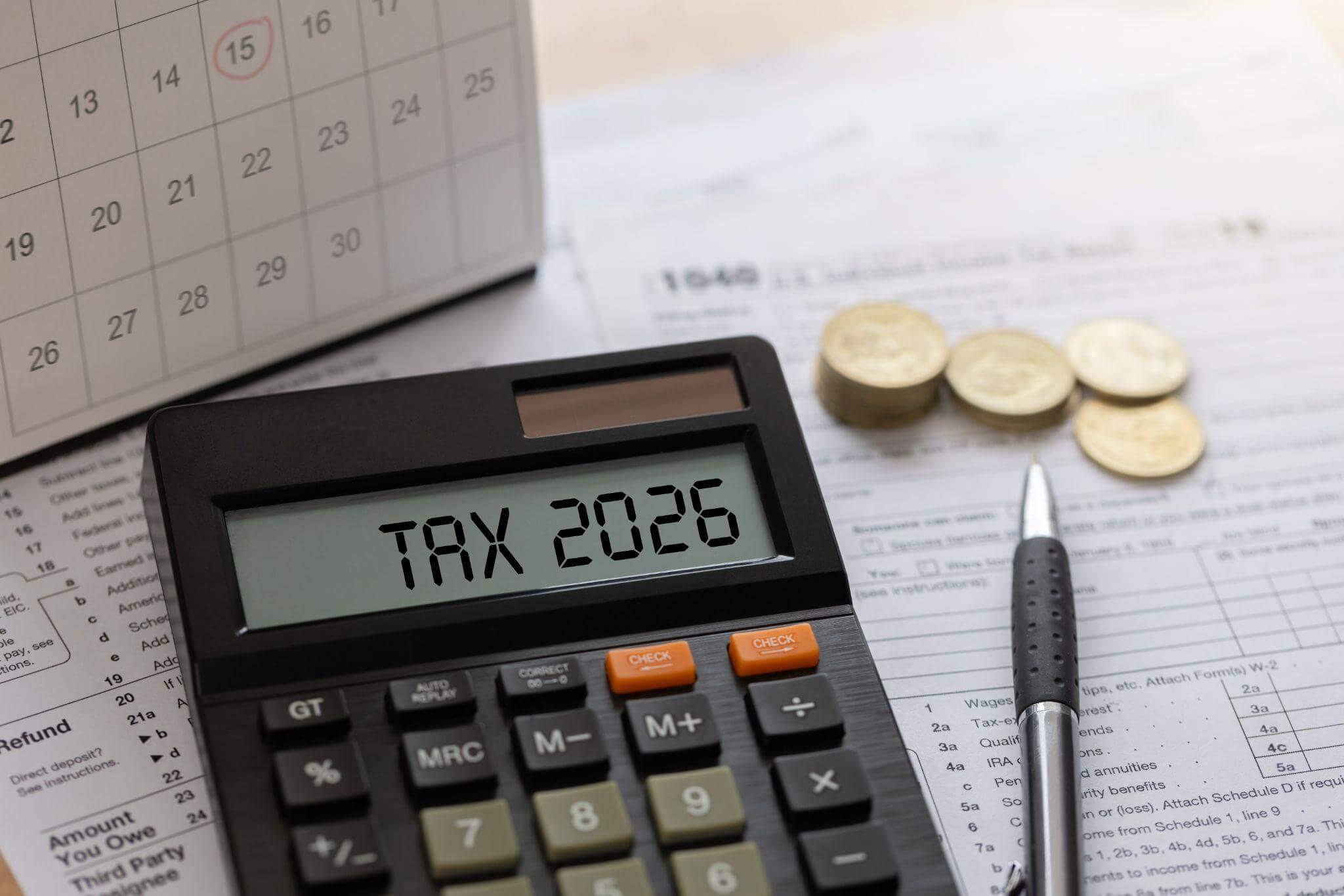 Calculator and pen on a desk with legend "Tax 2026"