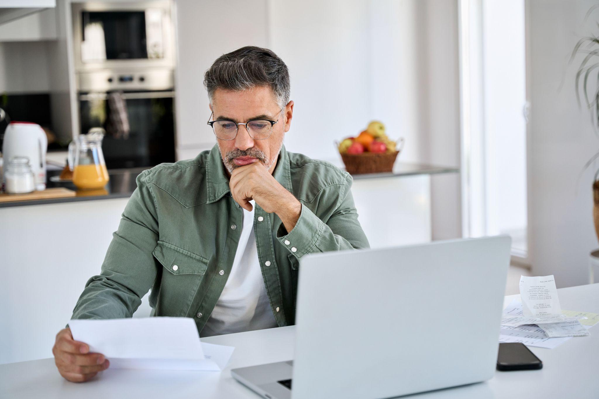 Man working on laptop in the kitchen