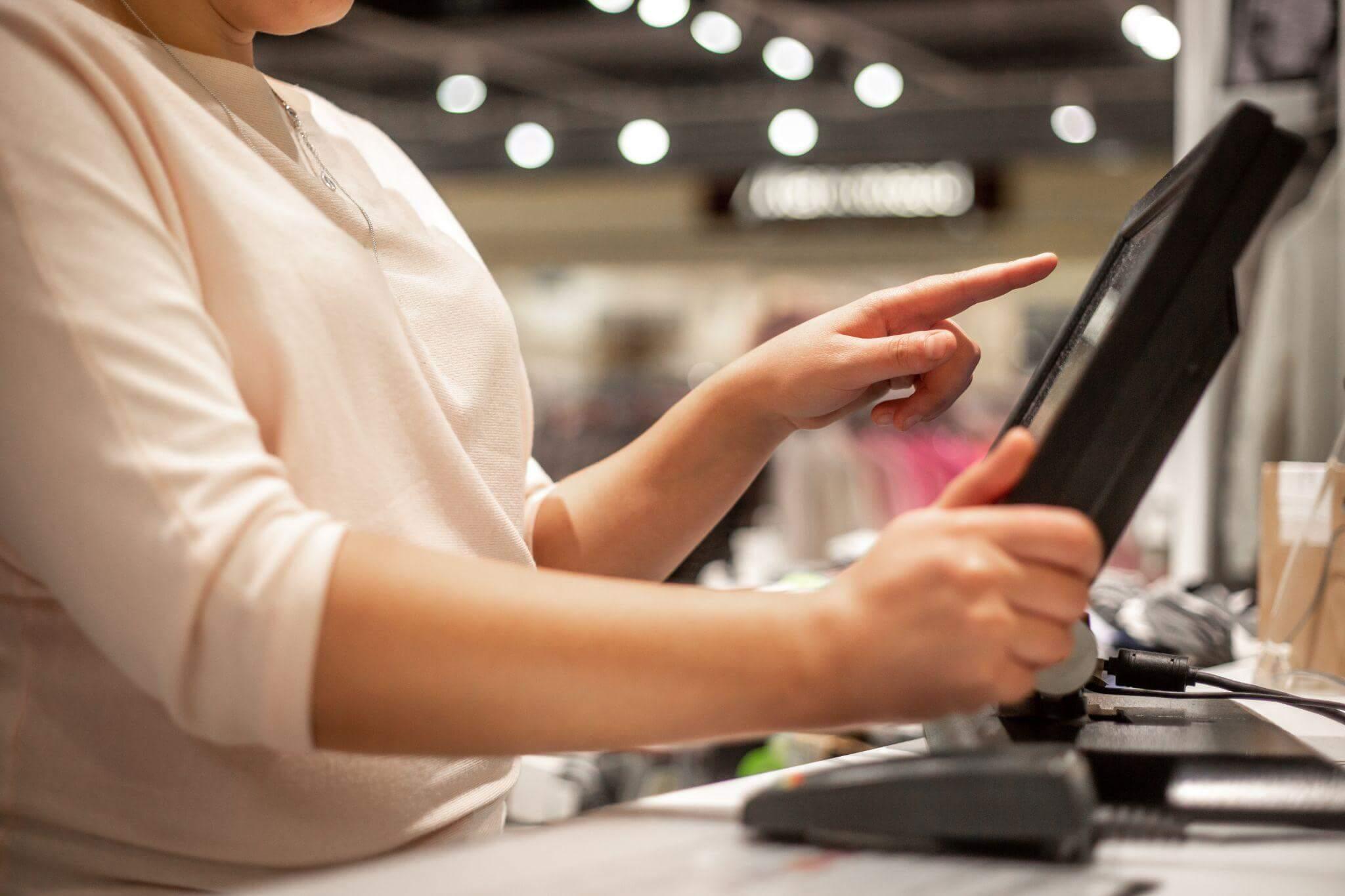a woman using a tablet computer in a store