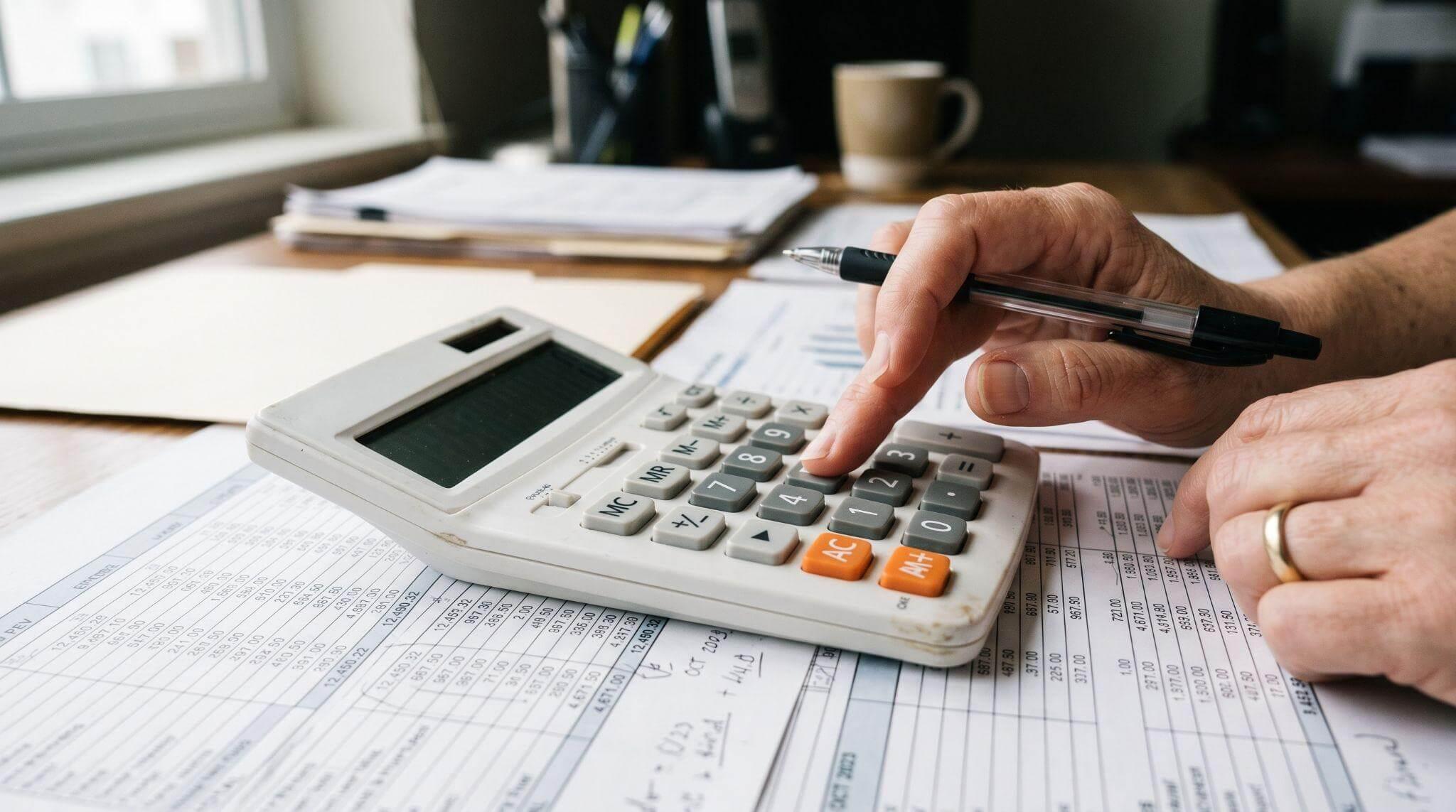 Person using a calculator for estimated taxes
