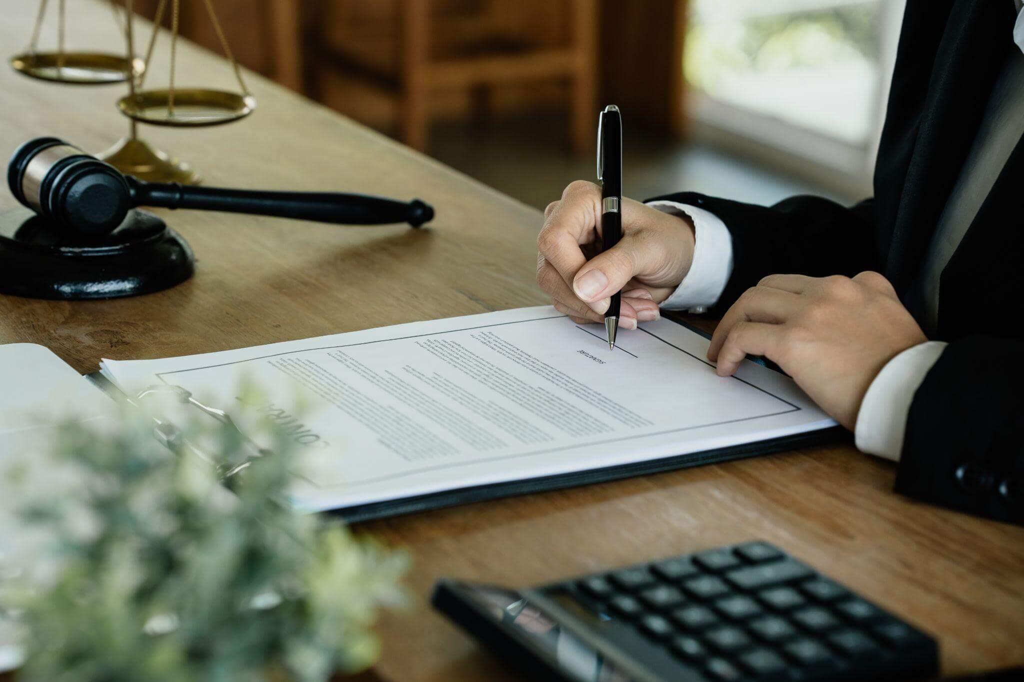 Man in suit writing notes about accounting services