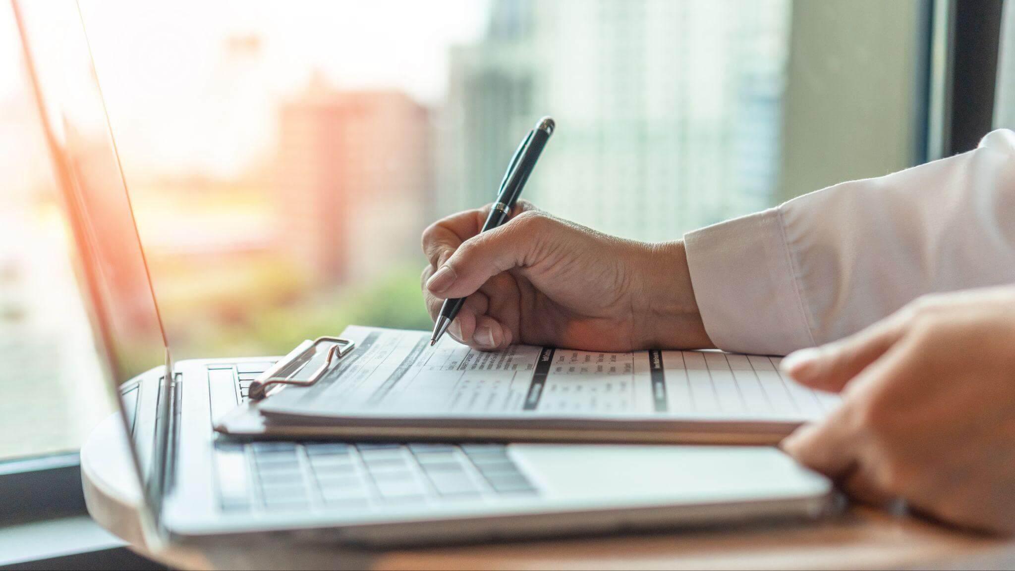 Person taking notes on LLC costs in Georgia